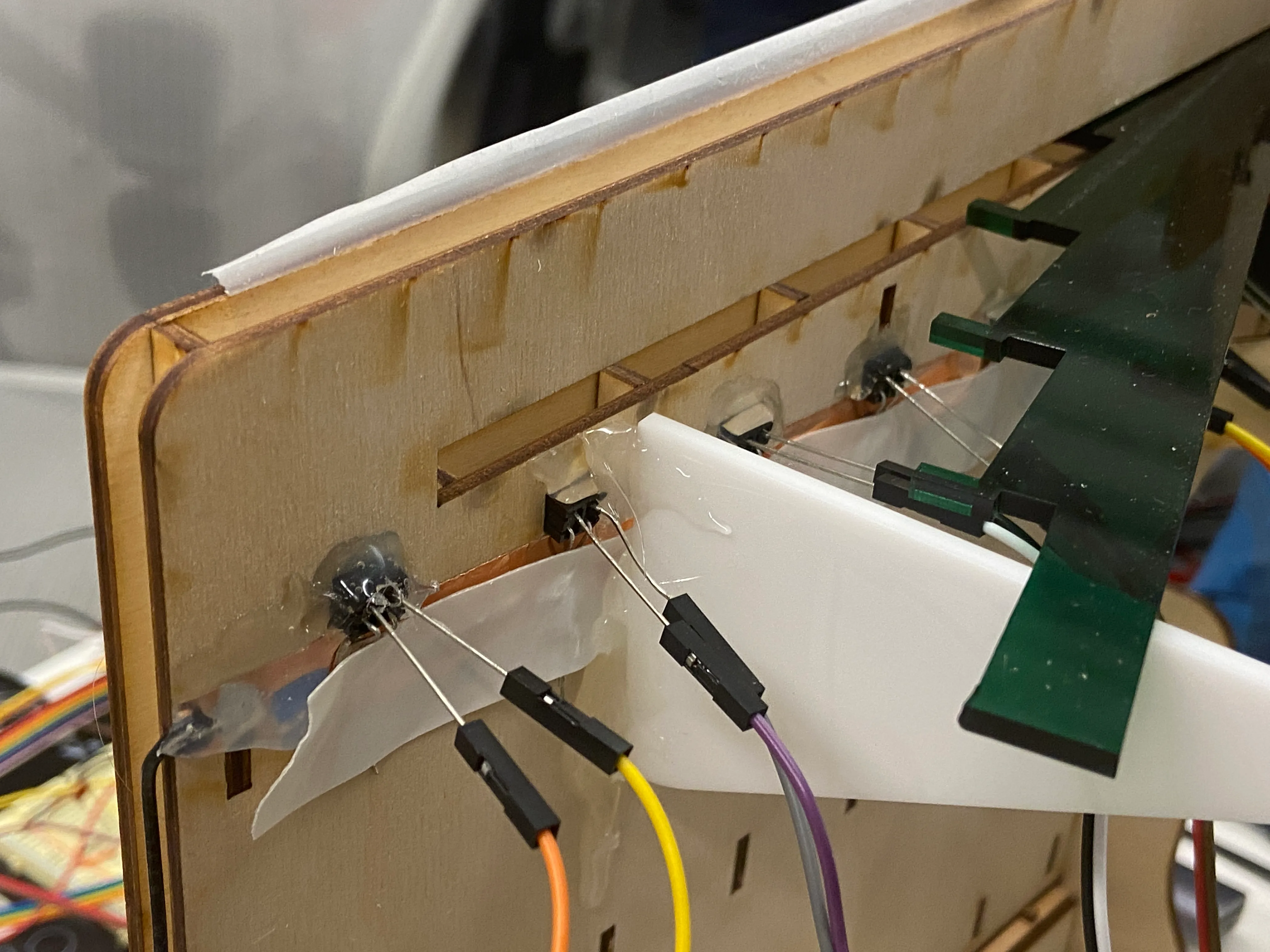 Photointerrupters on the back of the robot with copper tape