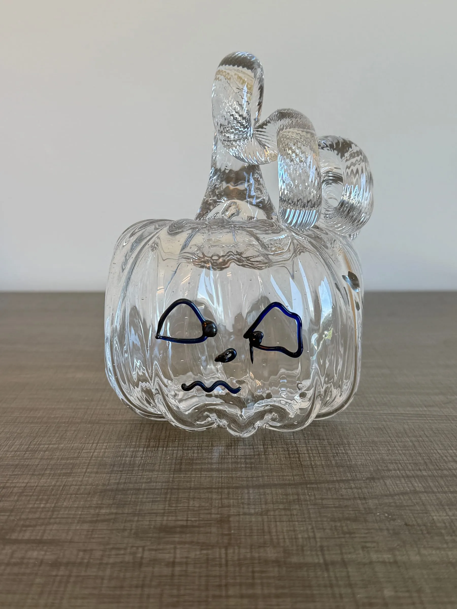 A pumpkin with a curly stem