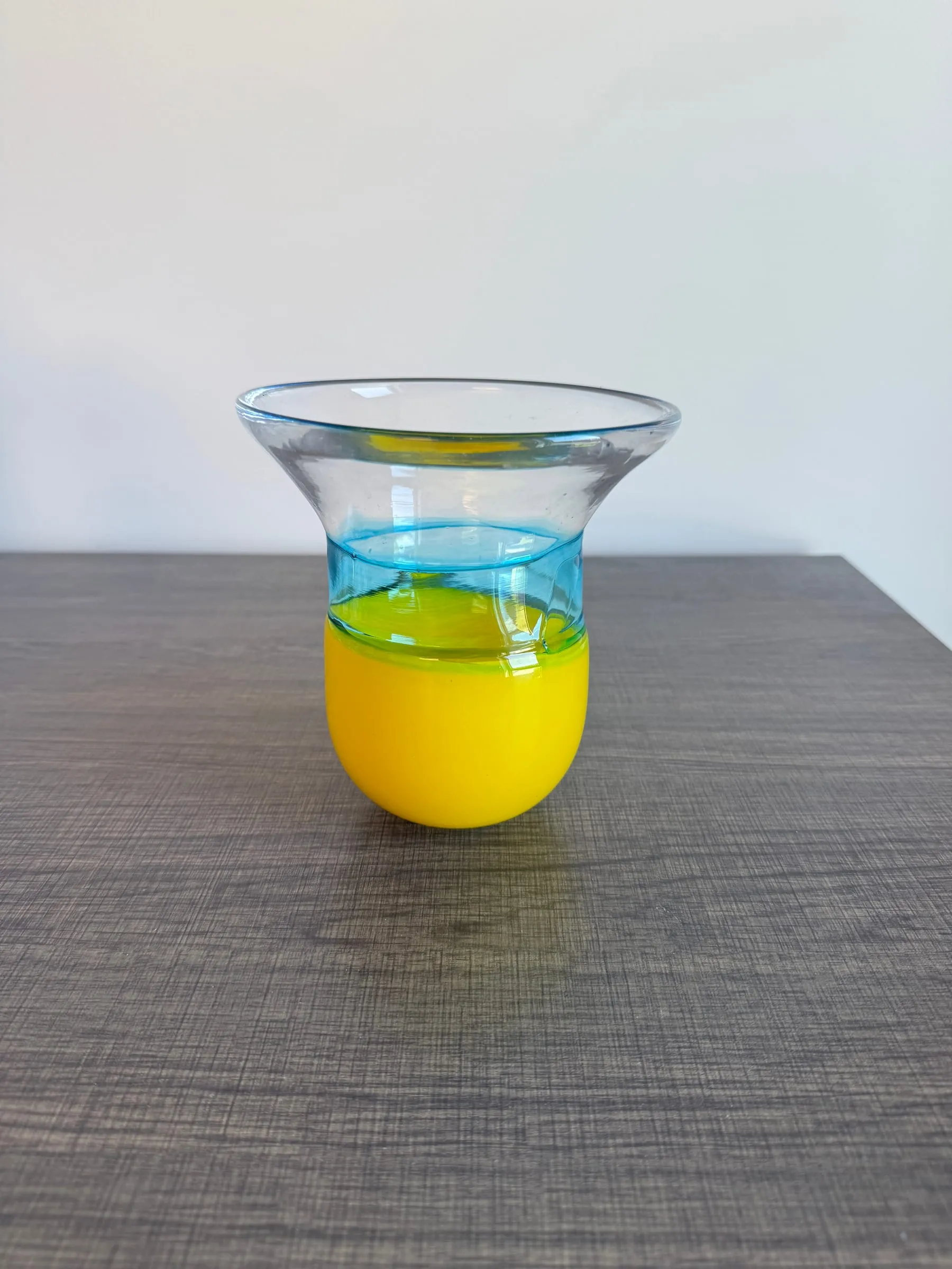 A yellow cup with a blue band